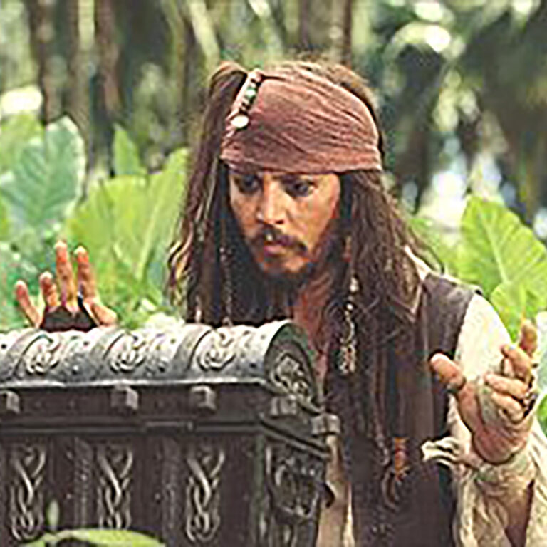 Johnny Depp as pirate looking at treasure chest