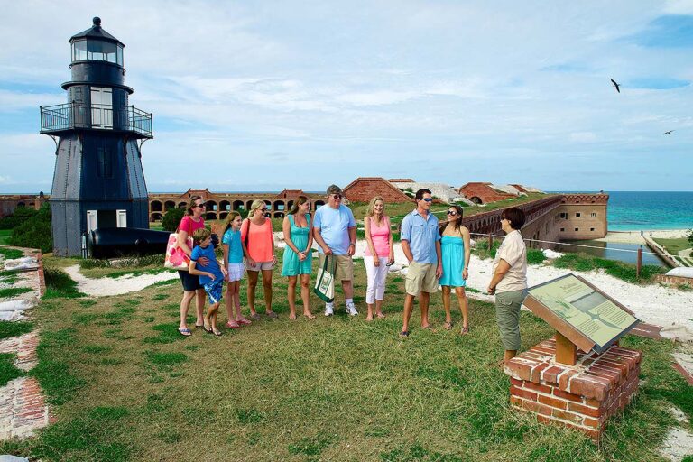 host and guests next to Fort Jefferson lighthouse